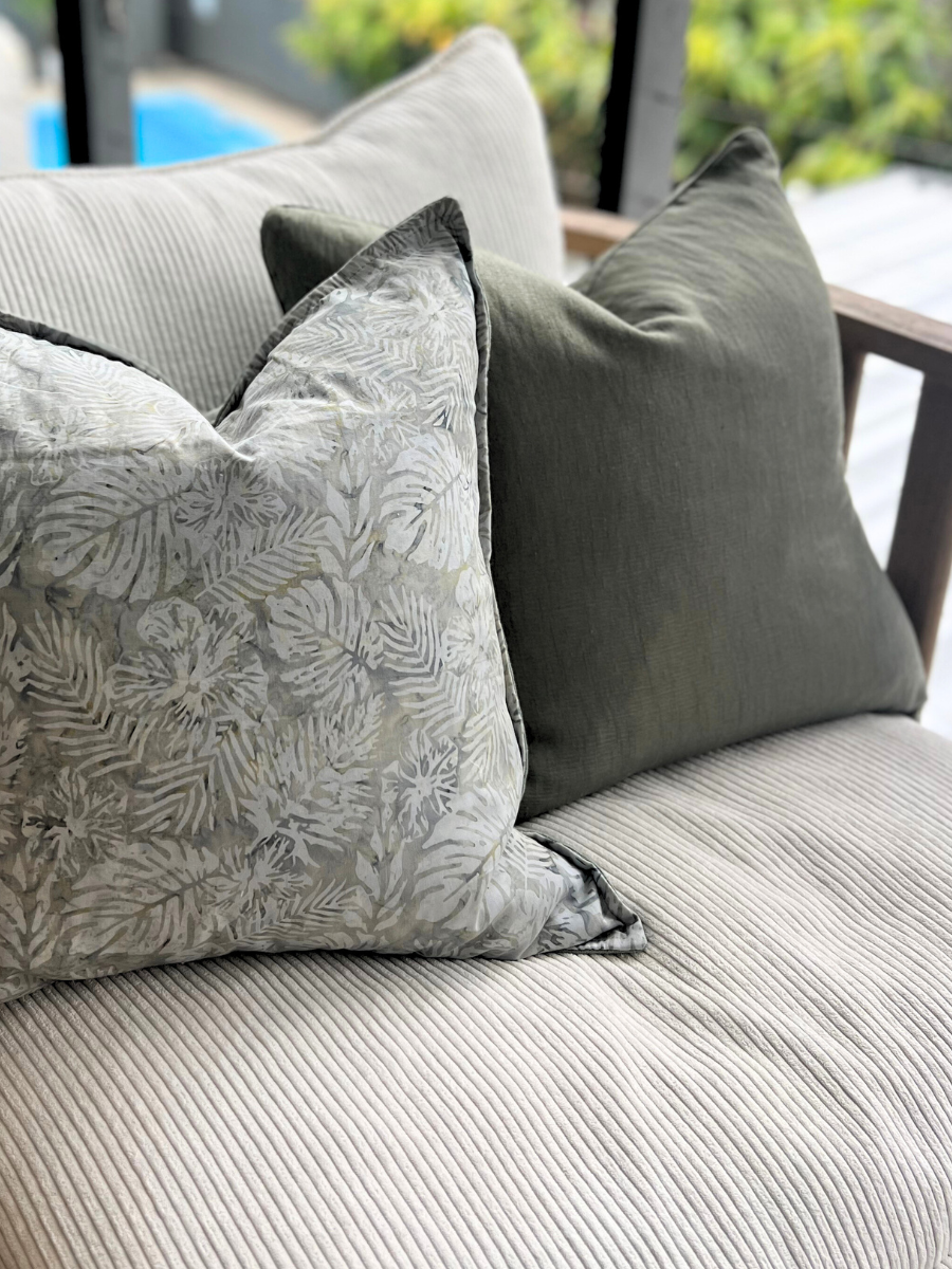 Square linen cushions in green and palm leaf print